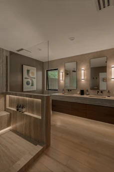 Modern bathroom with double vanity and shower area