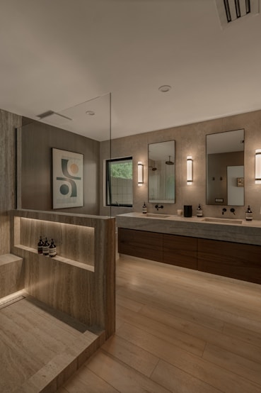 Modern bathroom with double vanity and shower area.