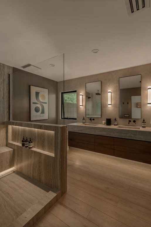 Modern bathroom with double vanity and shower area