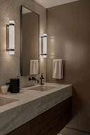 Modern bathroom vanity with double sinks and wall sconces
