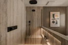 Modern bathroom with stone tile and recessed lighting.