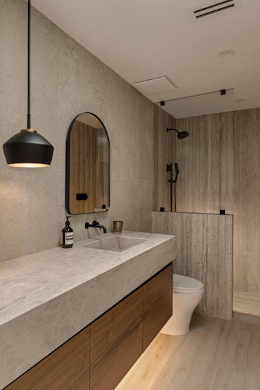 Modern bathroom with wood vanity and stone tiles
