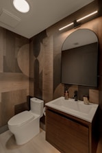 Modern bathroom with wood-patterned wallpaper and vanity.