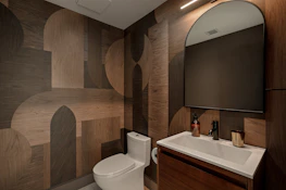 A modern bathroom with geometric patterned walls.