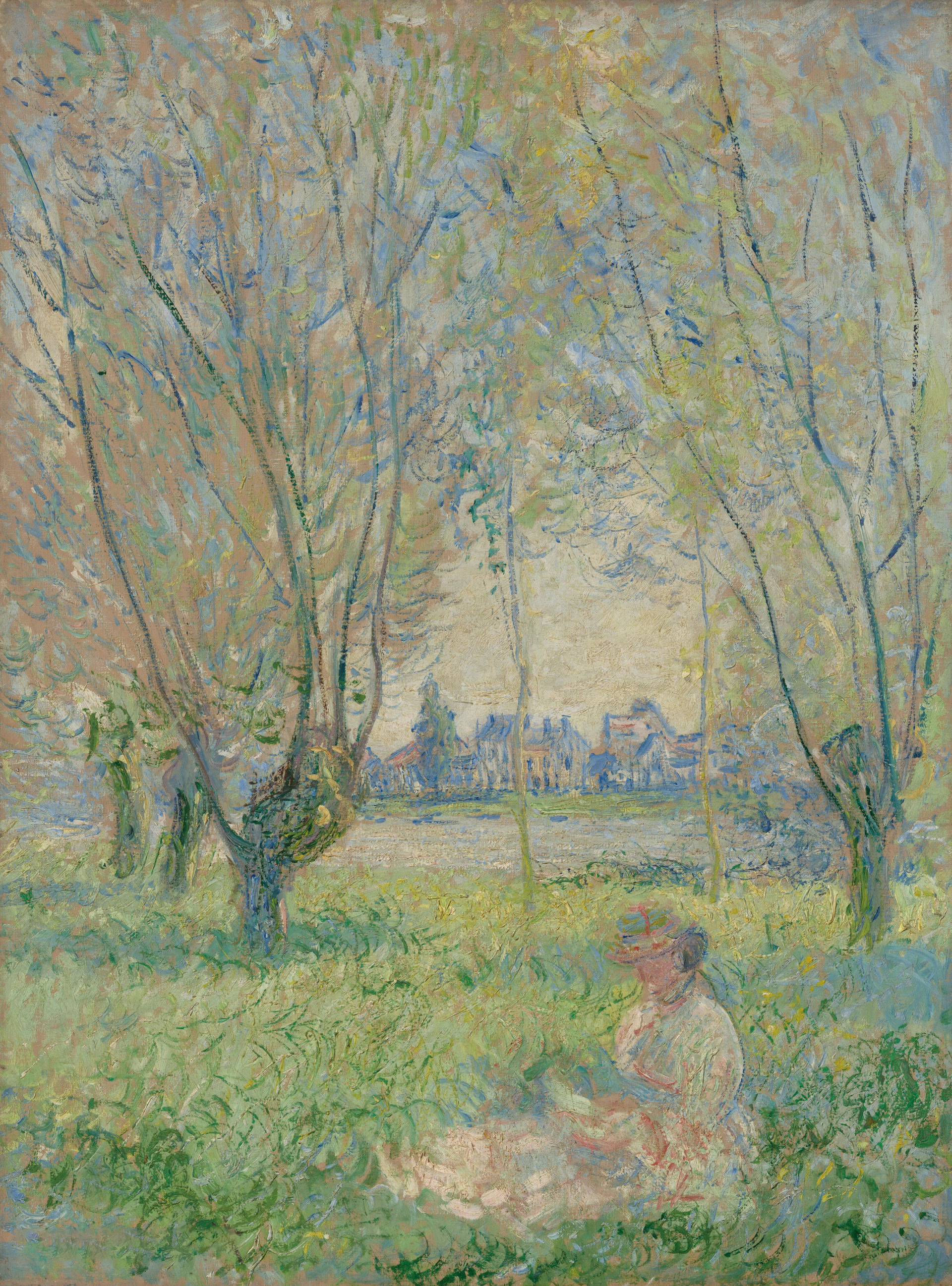 Woman in a straw hat sitting outdoors in a garden