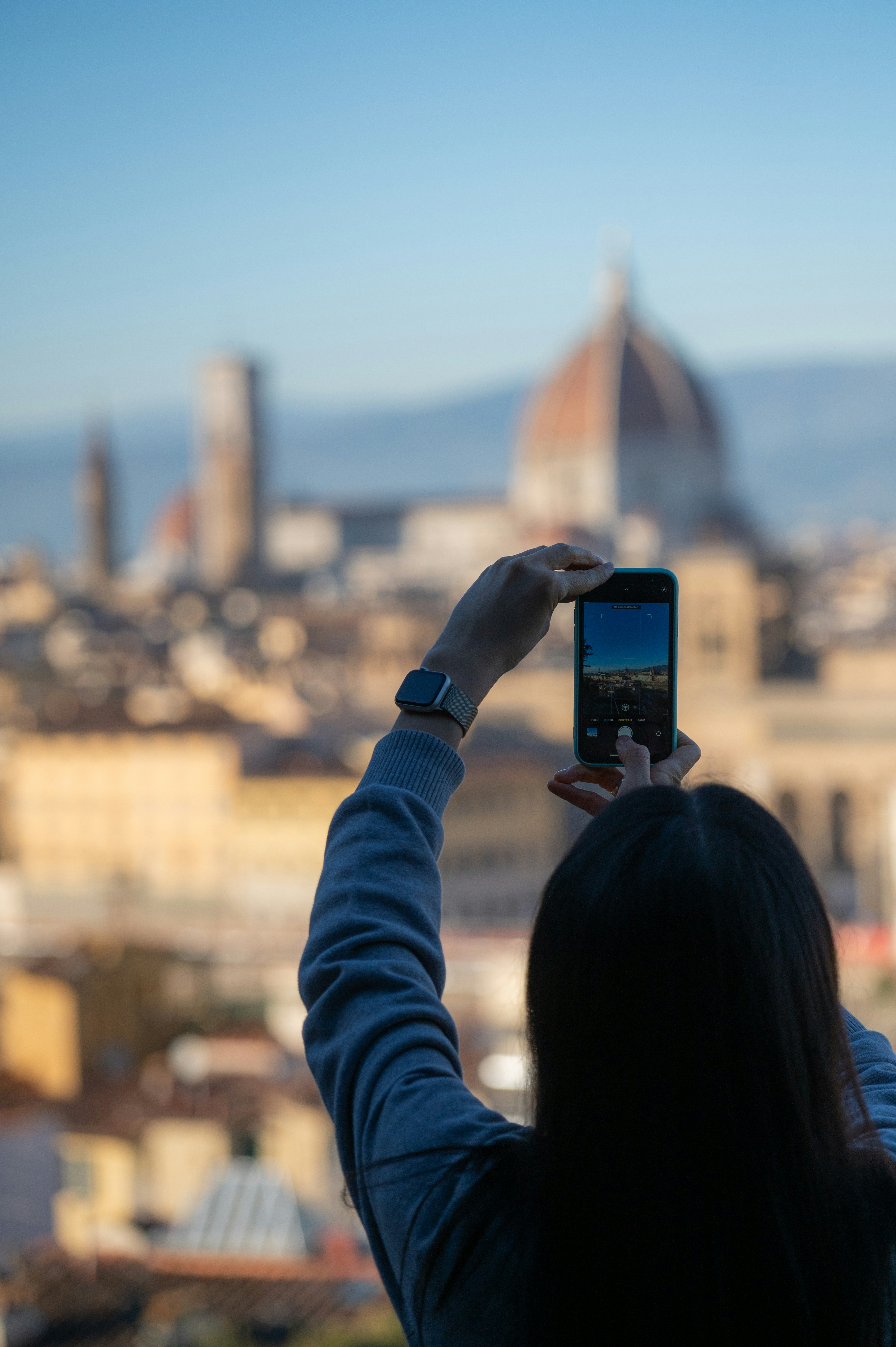 Woman takes a selfie with florence skyline in background