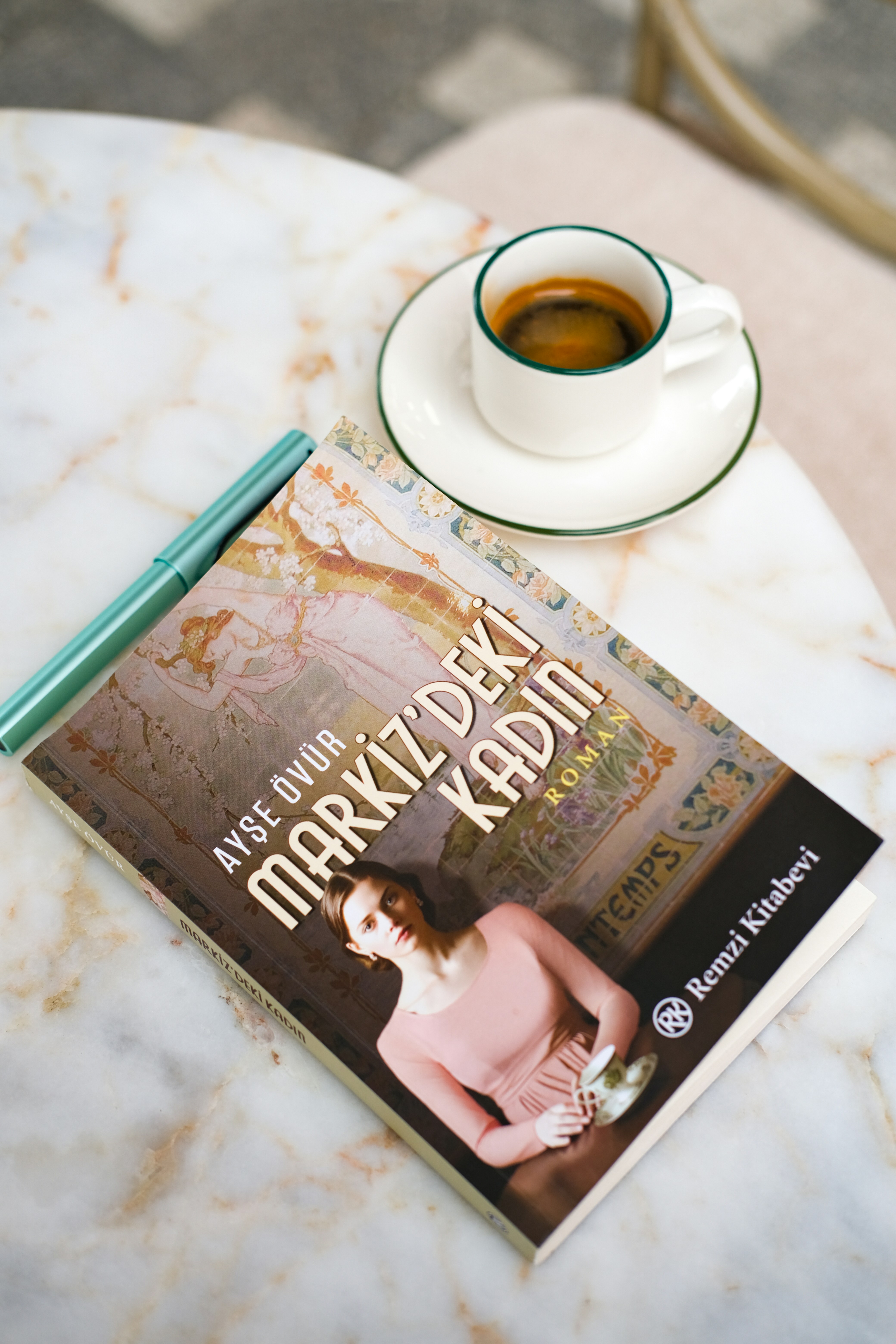 Book and coffee on a marble table