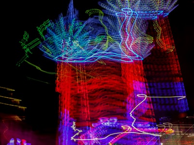 Blurred colorful lights of a carnival ride at night