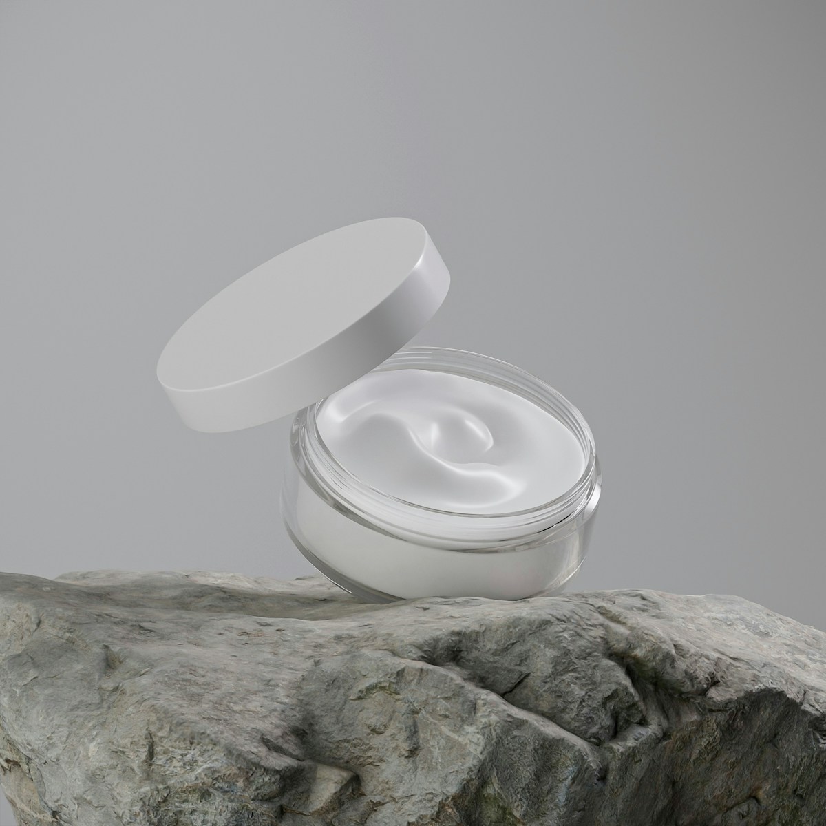 Open Cushion Cream jar with cushion-soft texture, on a natural stone slab
