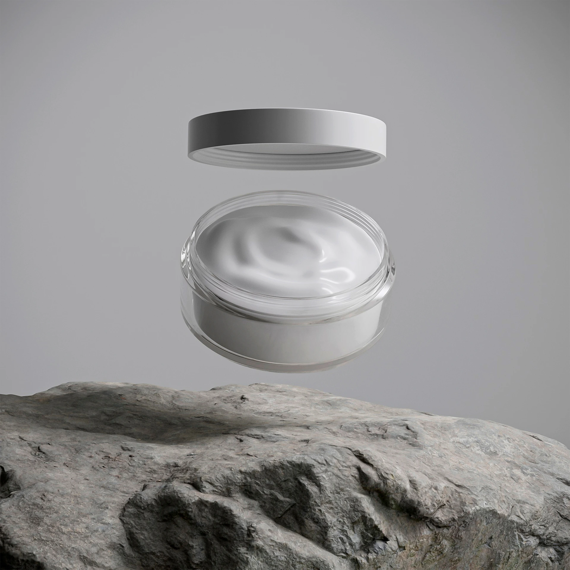 A jar of white cream floats above a rock.