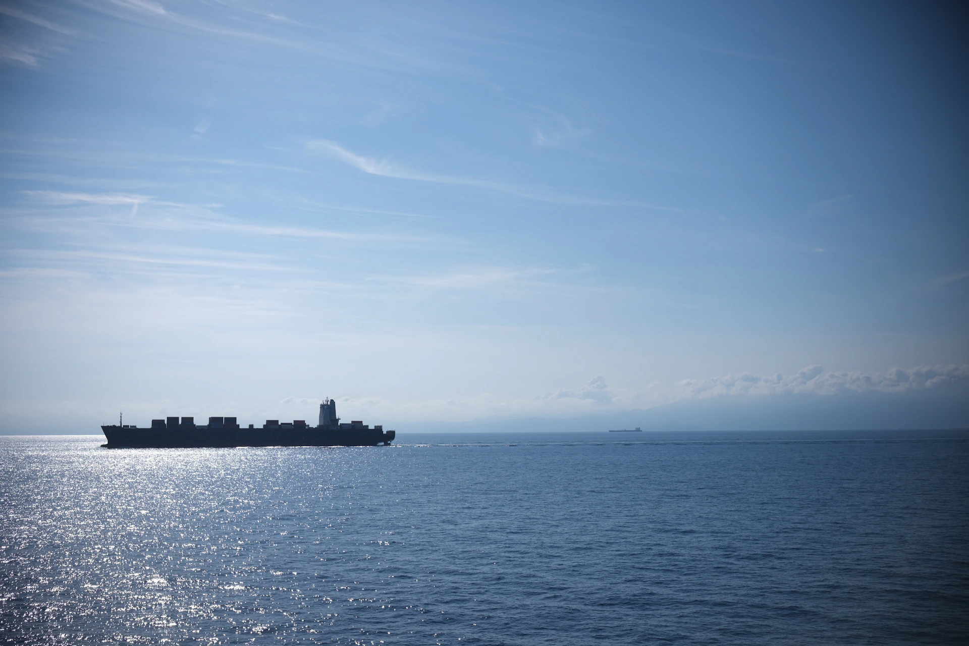 Cargo ship sailing on a calm blue ocean