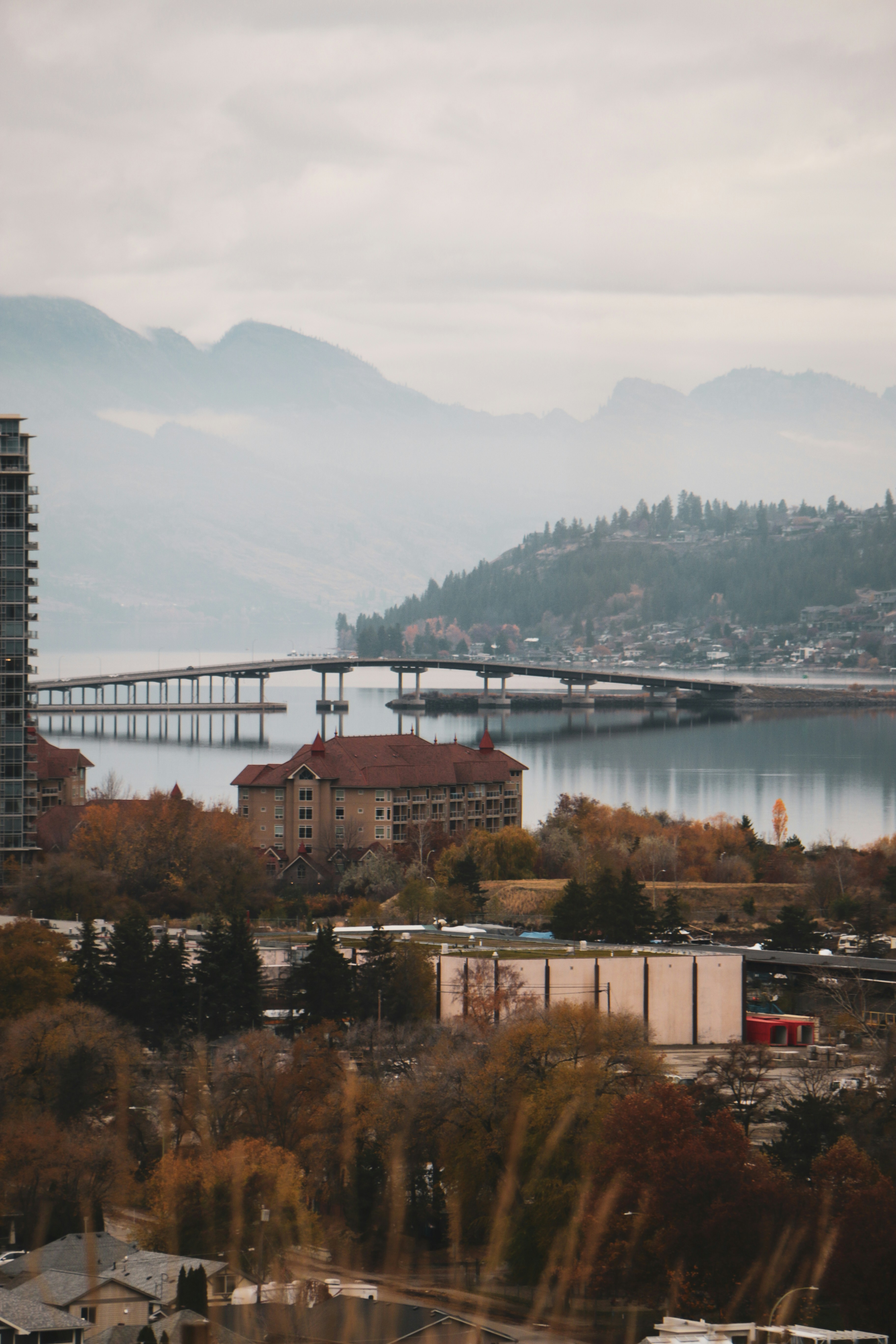 Bridge over a calm lake with distant mountains