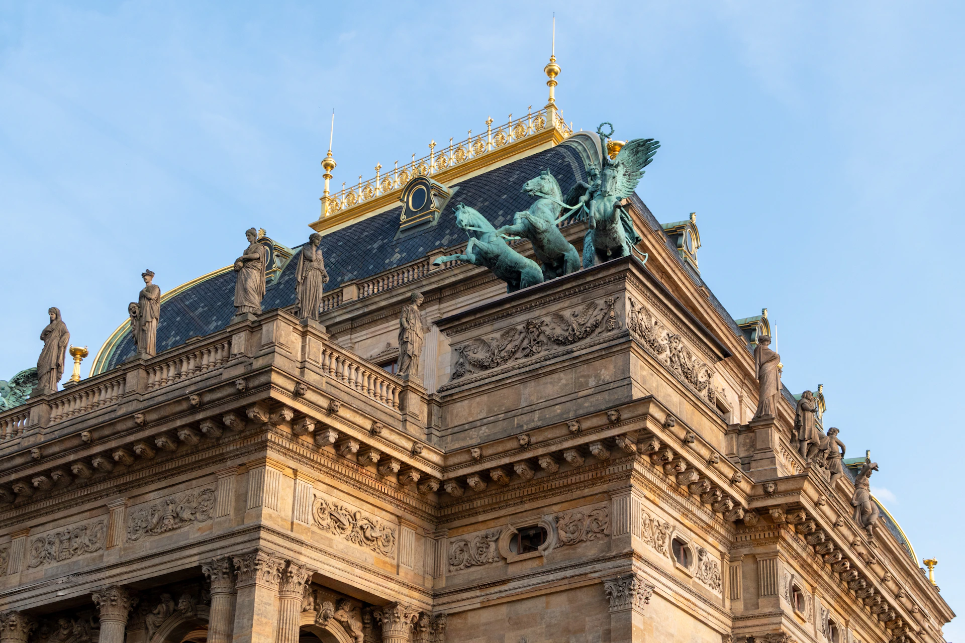 Ornate building facade with sculptures under a clear sky