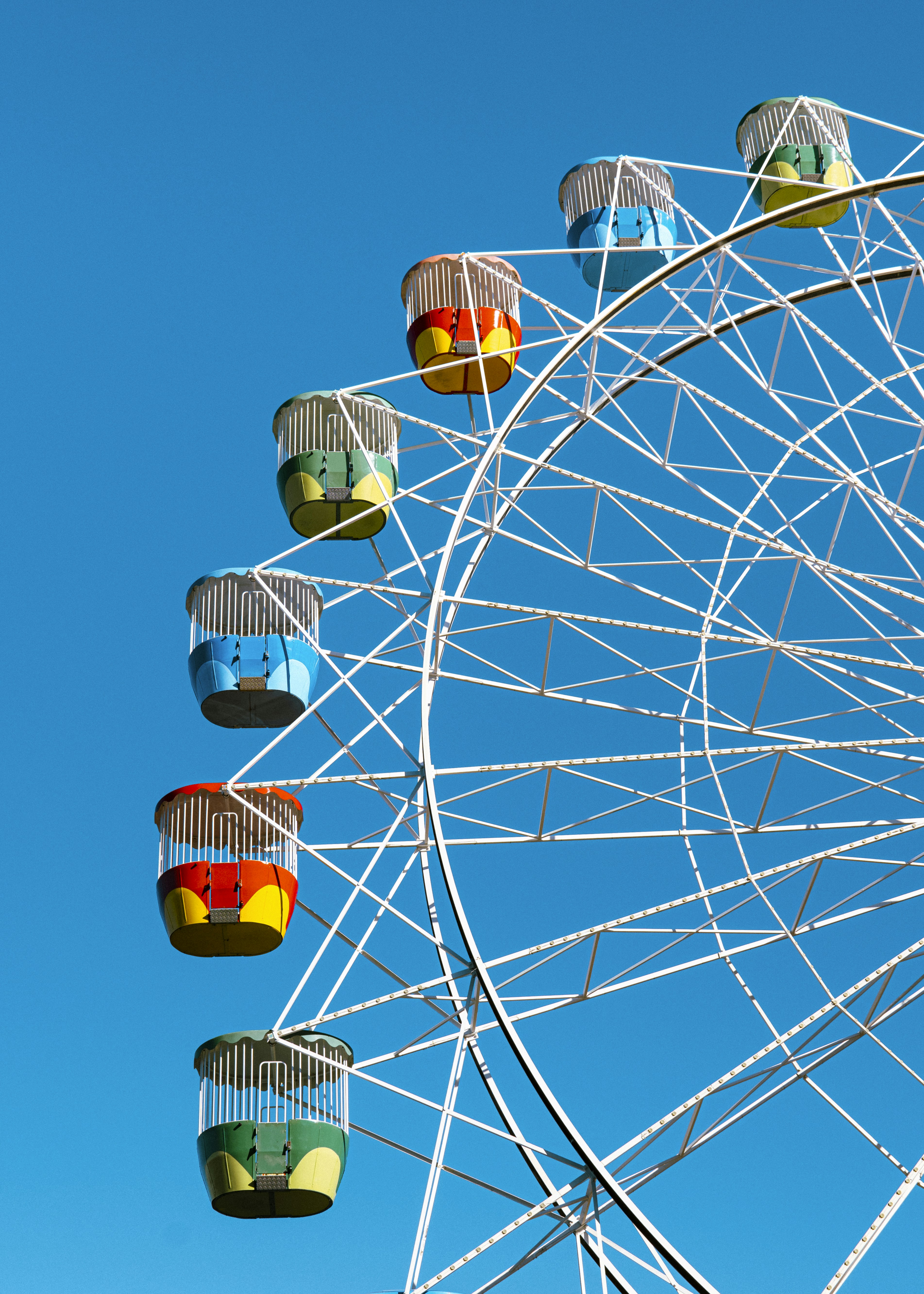 Colorful ferris wheel against a clear blue sky