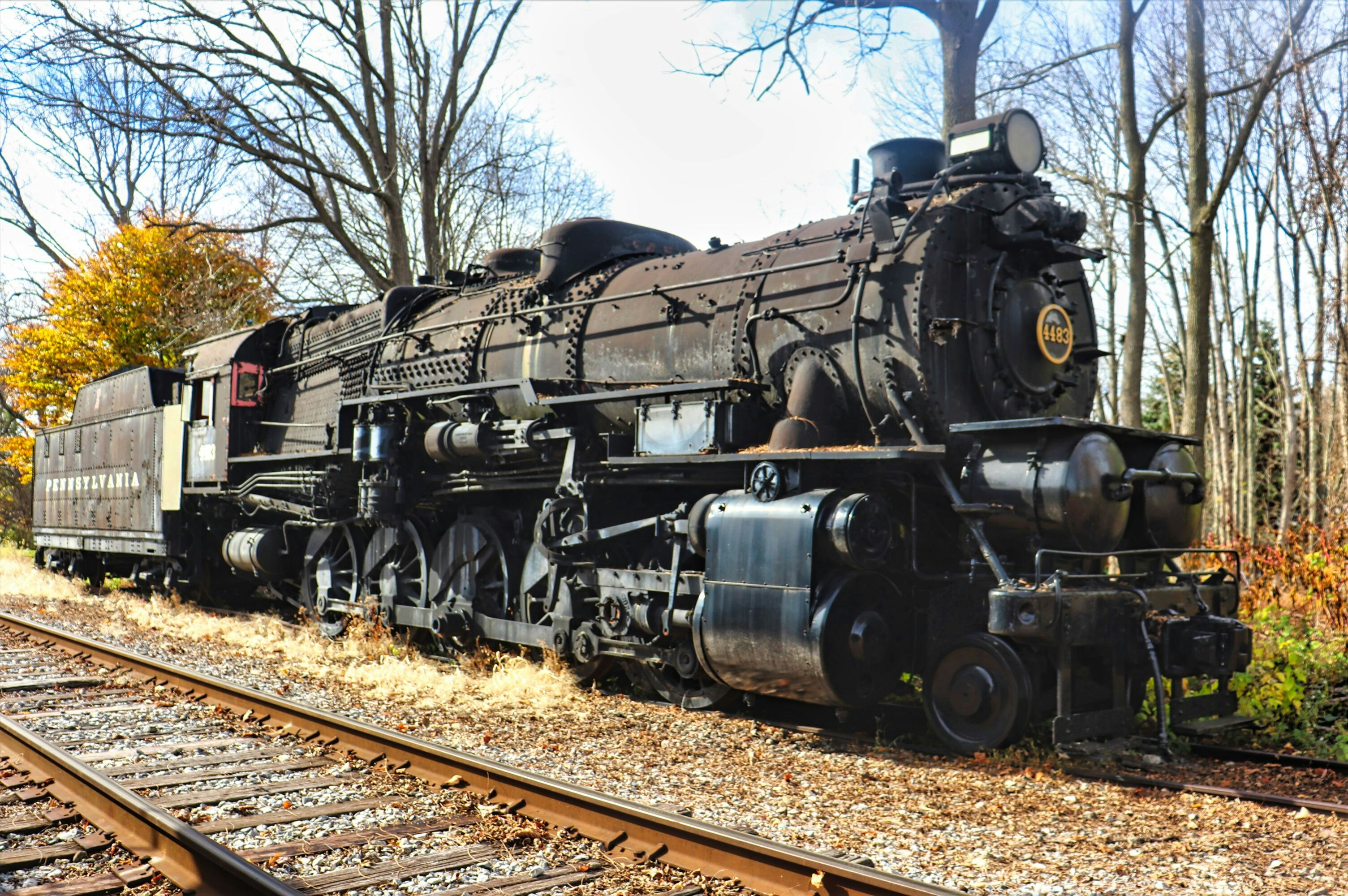 An old steam locomotive sits on railroad tracks.