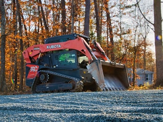 Orange kubota skid steer loader on gravel