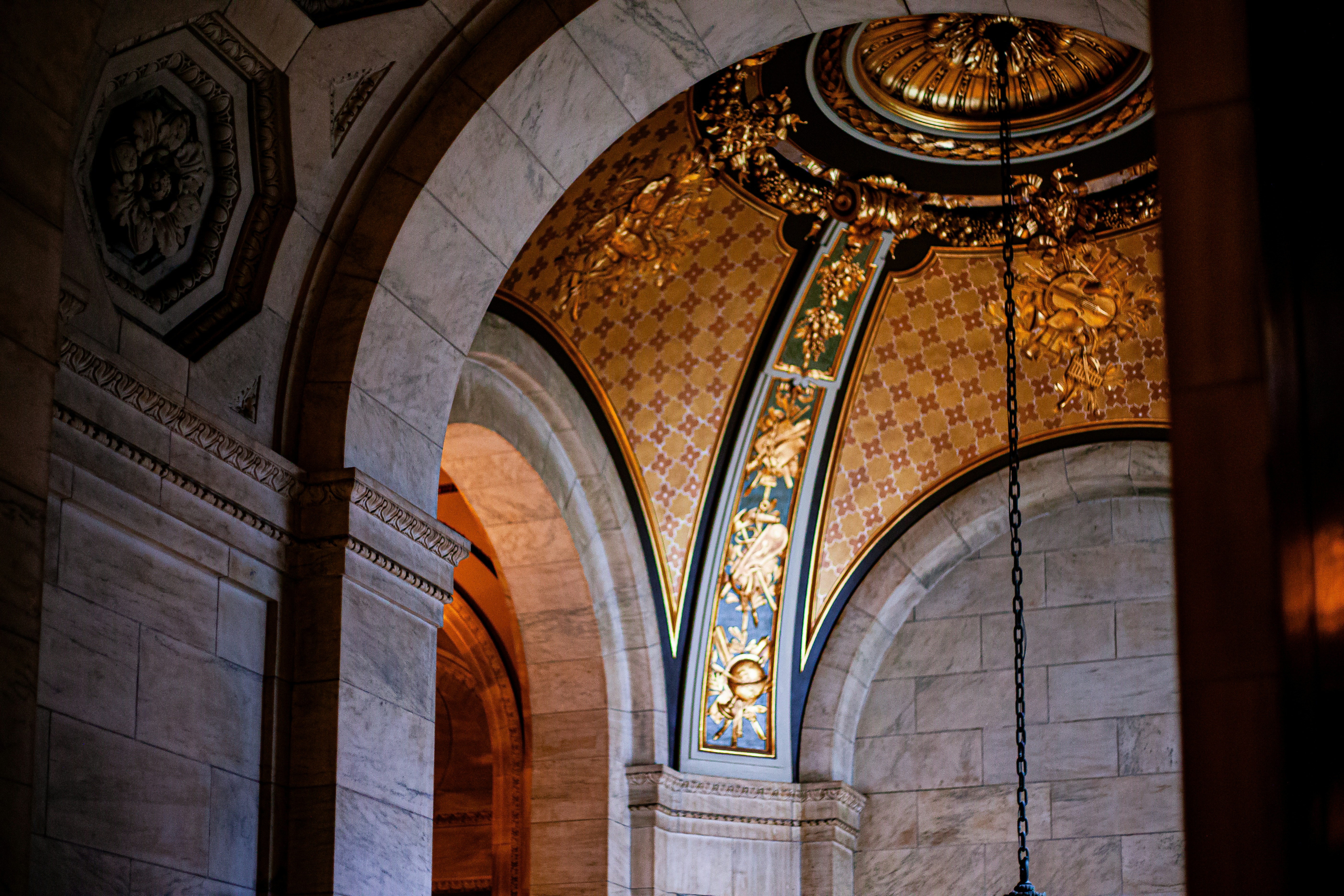Ornate golden ceiling inside grand stone architecture