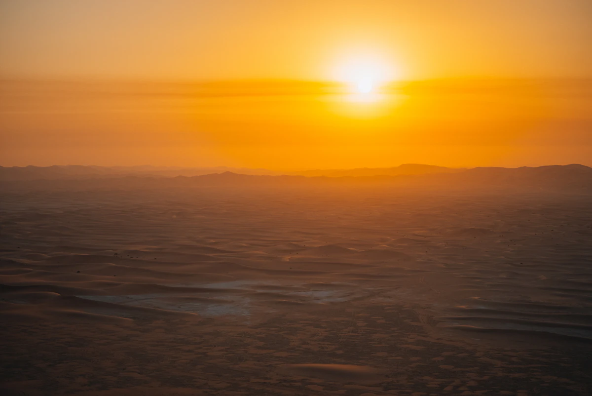 Sunset over layered sand dunes in the Dubai desert