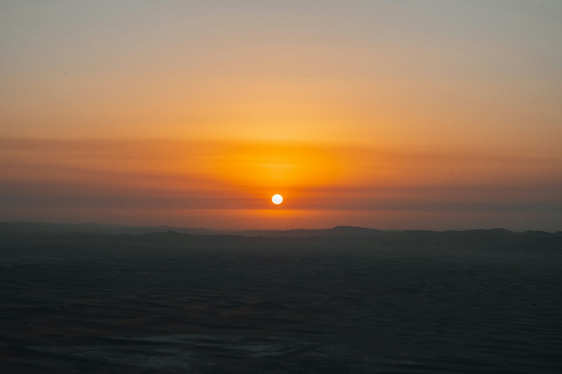 Sunrise over a hazy desert landscape