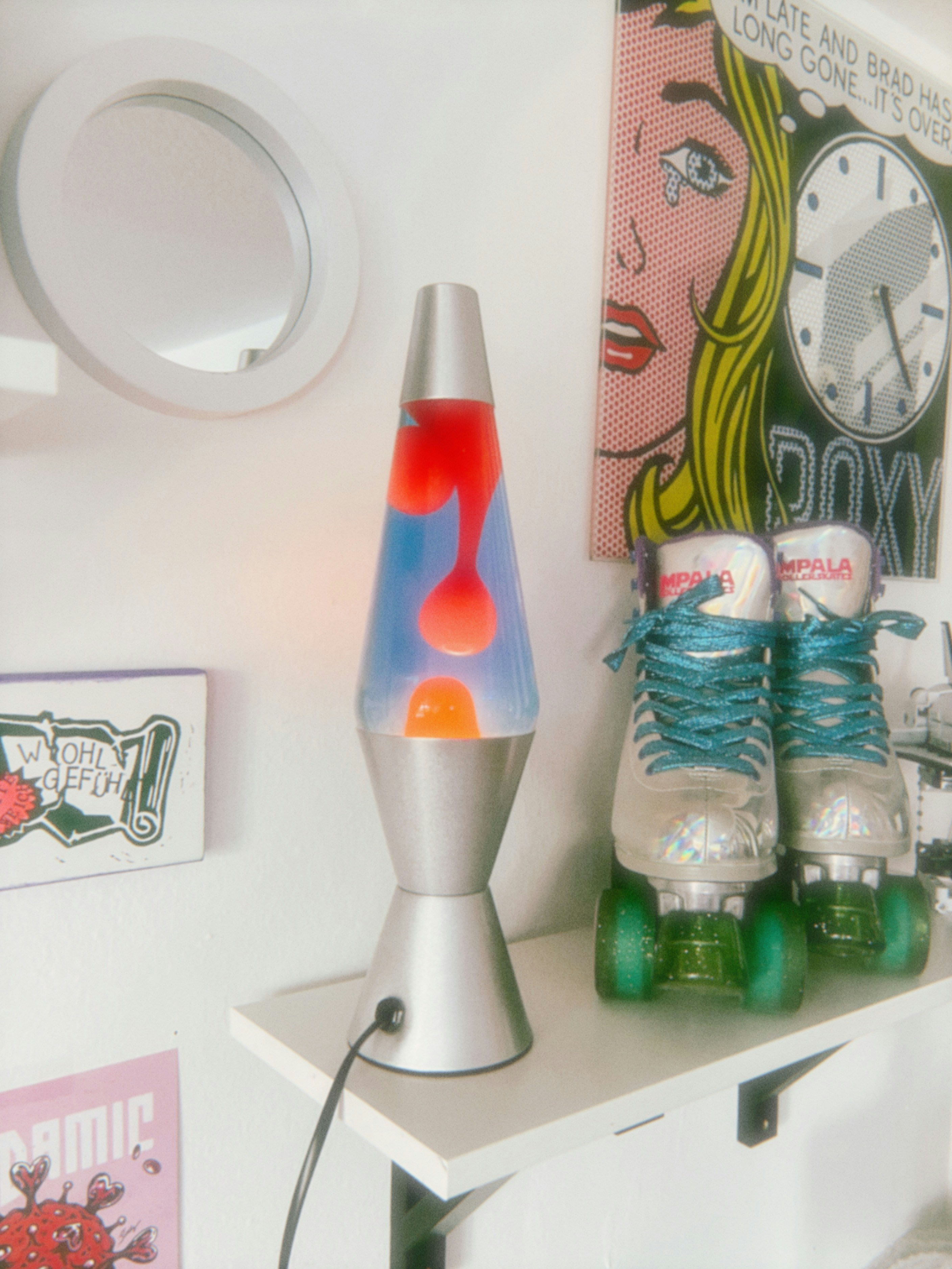 Retro lava lamp and roller skates on shelf