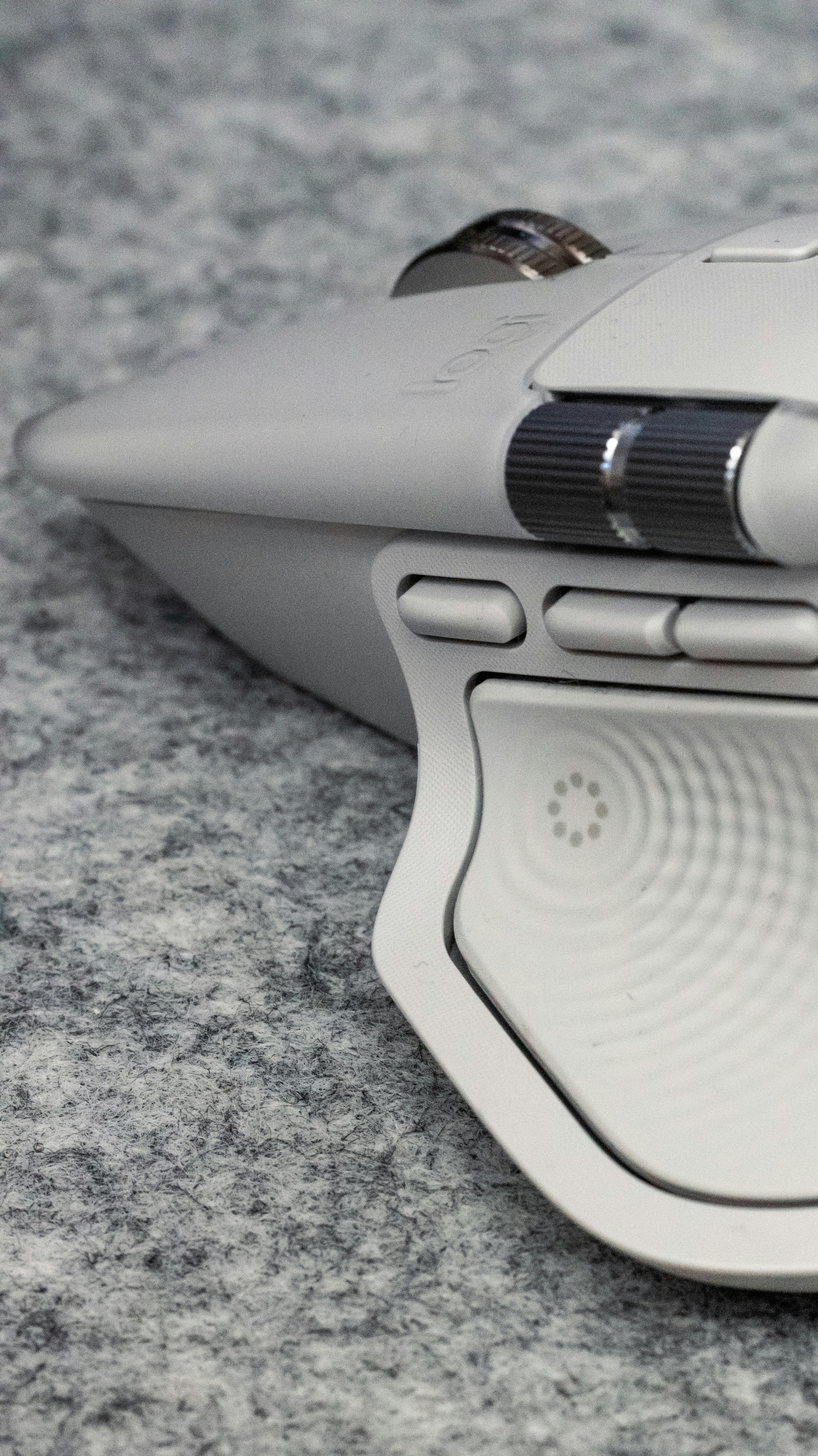 White computer mouse with scroll wheel on textured surface