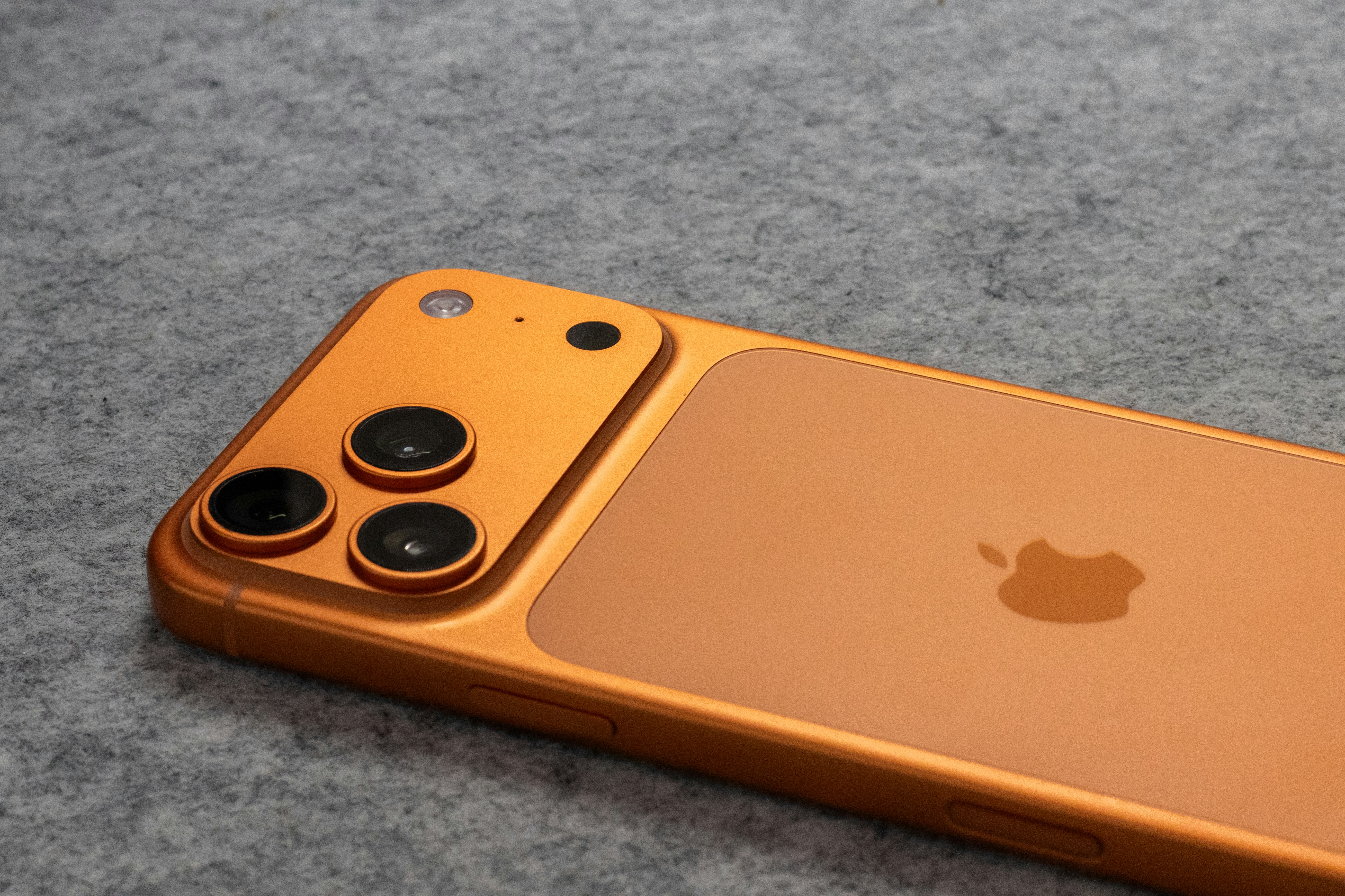 Orange smartphone with triple camera system