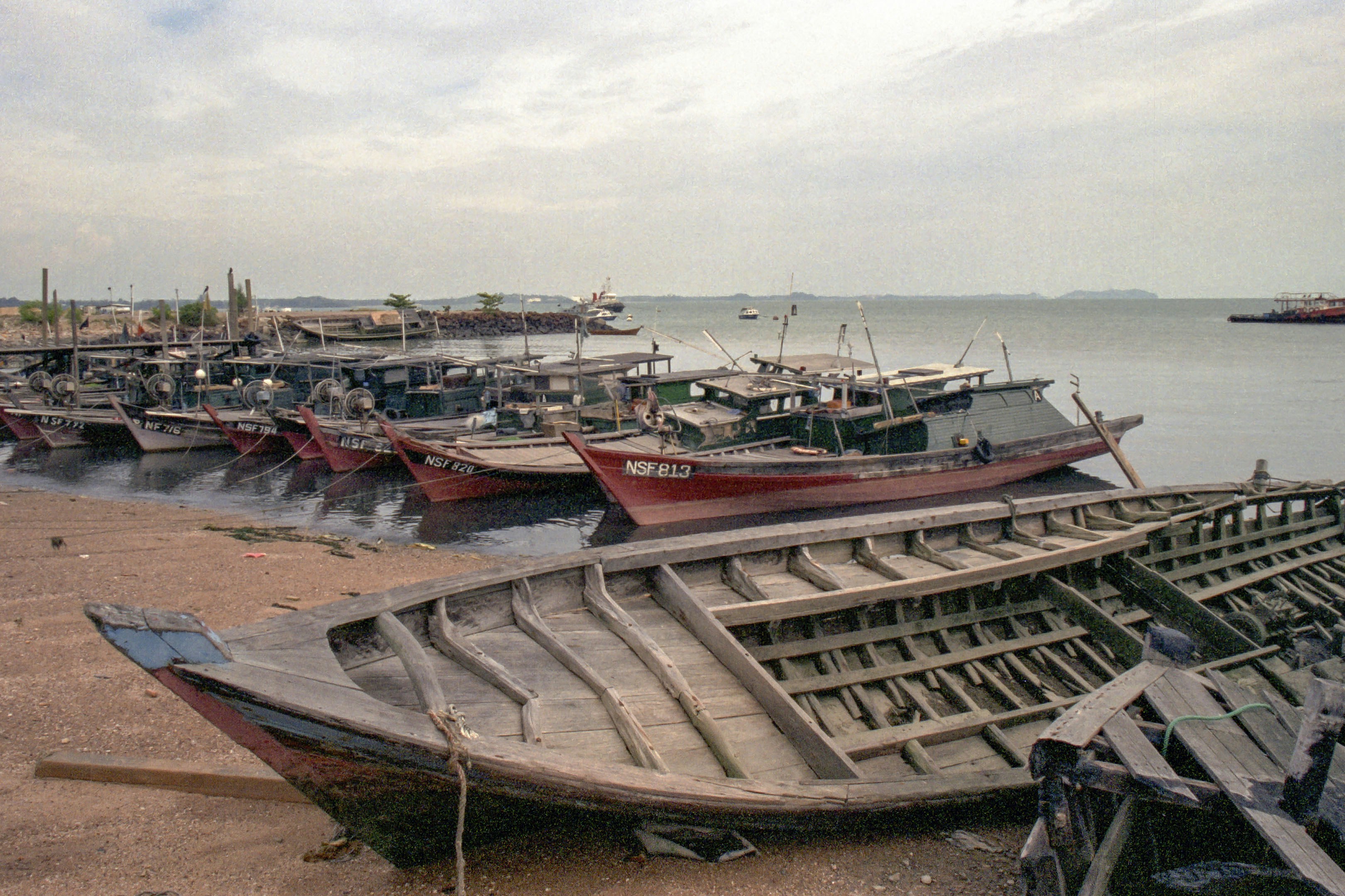 Fishing boats docked along a sandy shore