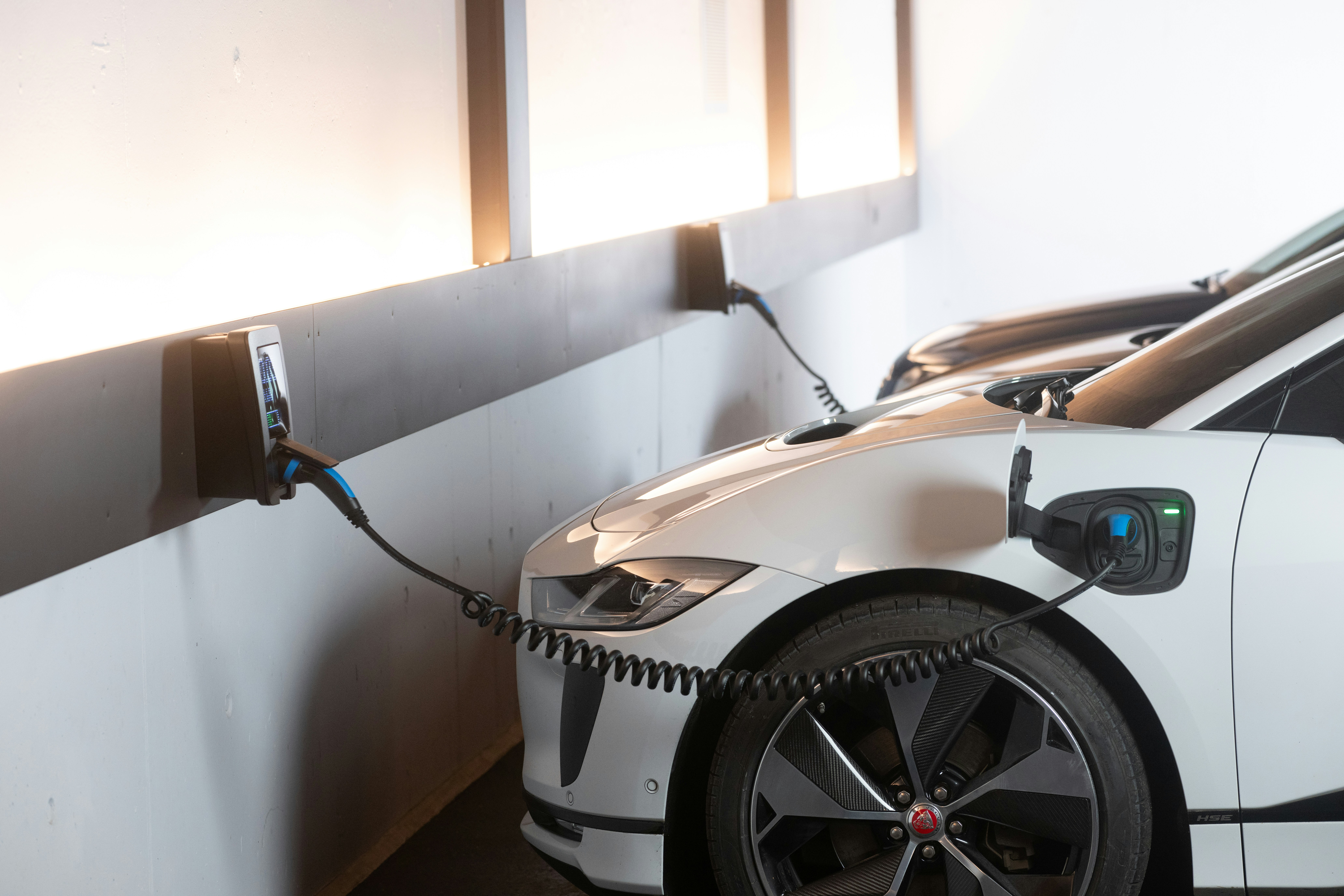 Image of a sleek electric sports car charging in a modern setting