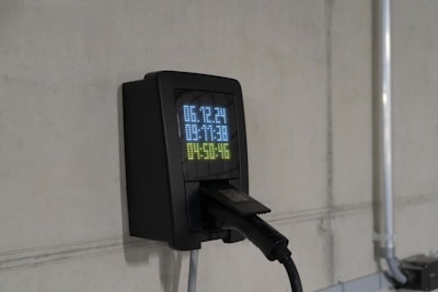 Electric car charger on a concrete wall