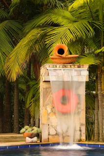 Water feature with terracotta pot and life preserver.