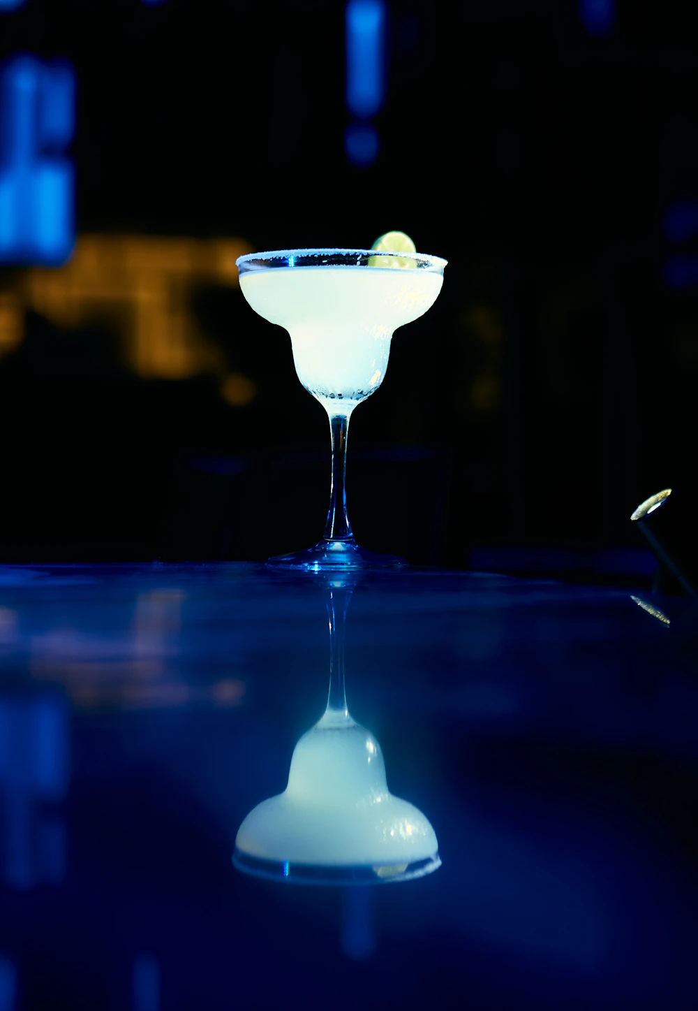 Margarita with lime on a dark bar