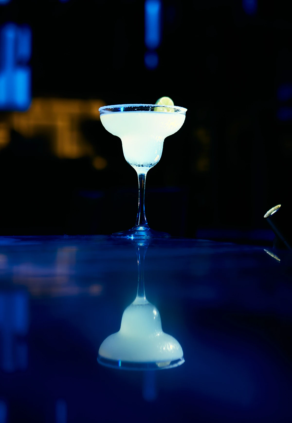 Margarita cocktail with lime in a dimly lit bar