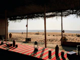 Desert oasis seating area overlooking sandy dunes