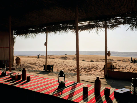 Desert oasis seating area overlooking sandy dunes
