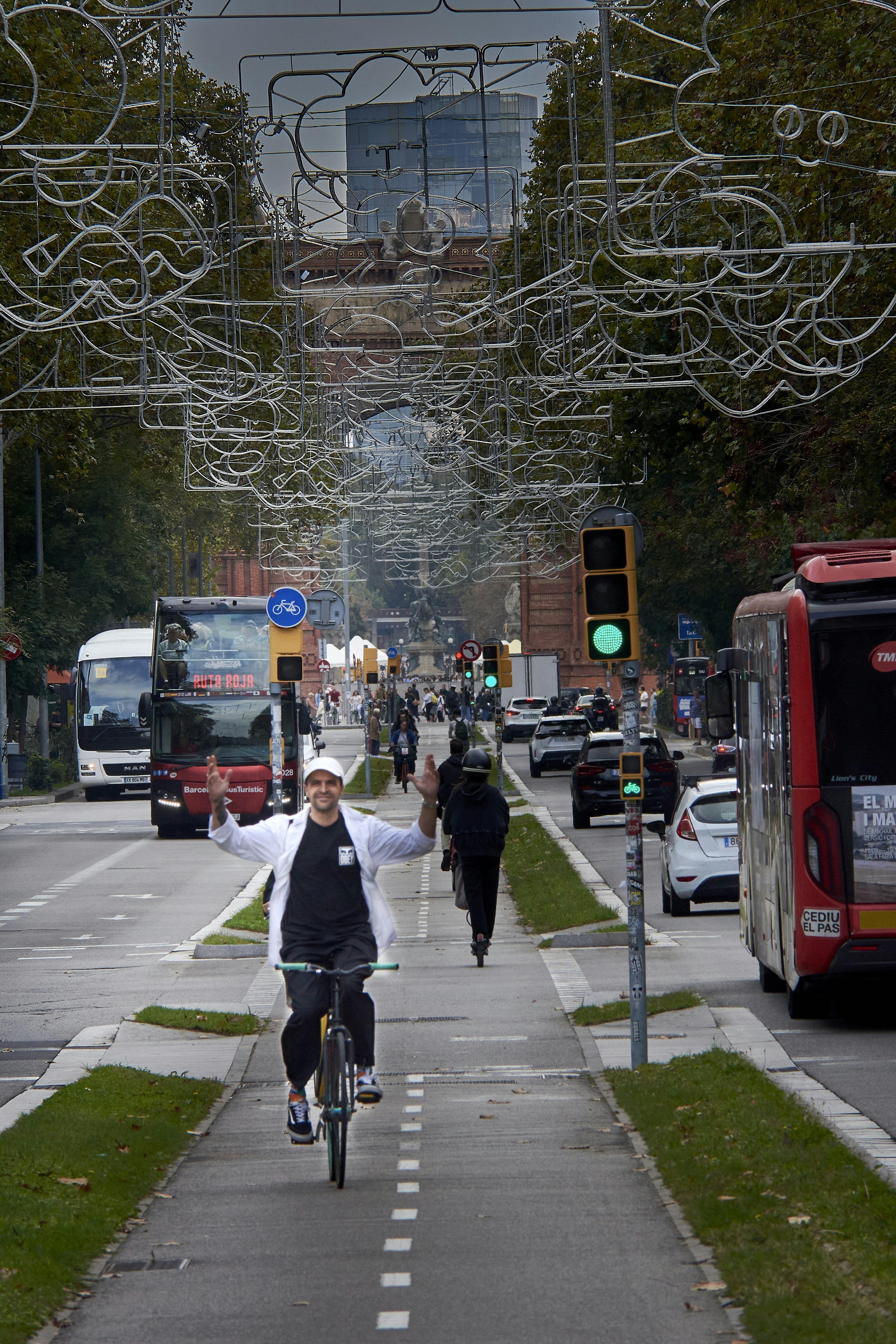 Man cycling on a bike lane with city traffic