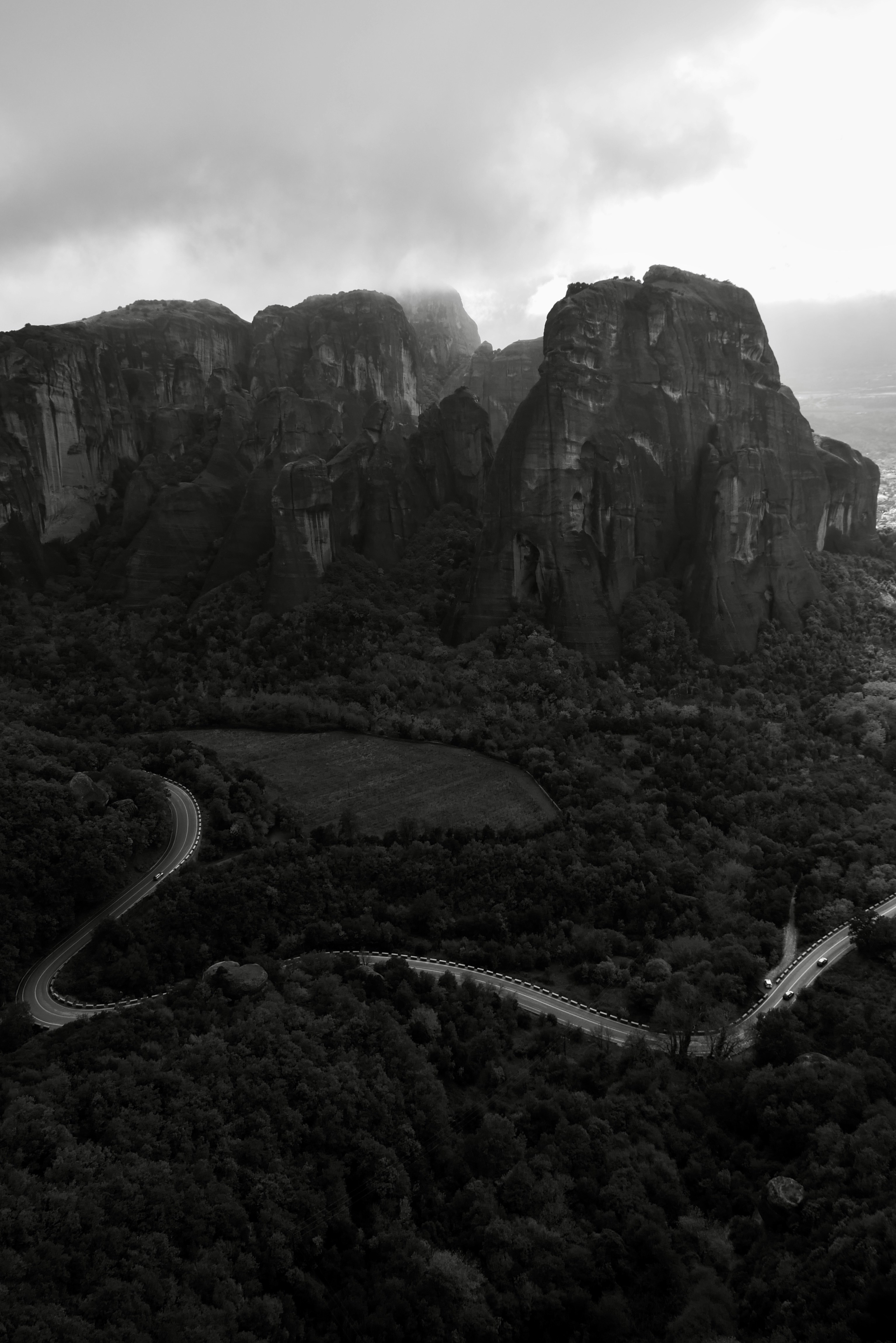 Winding mountain road through lush green forest