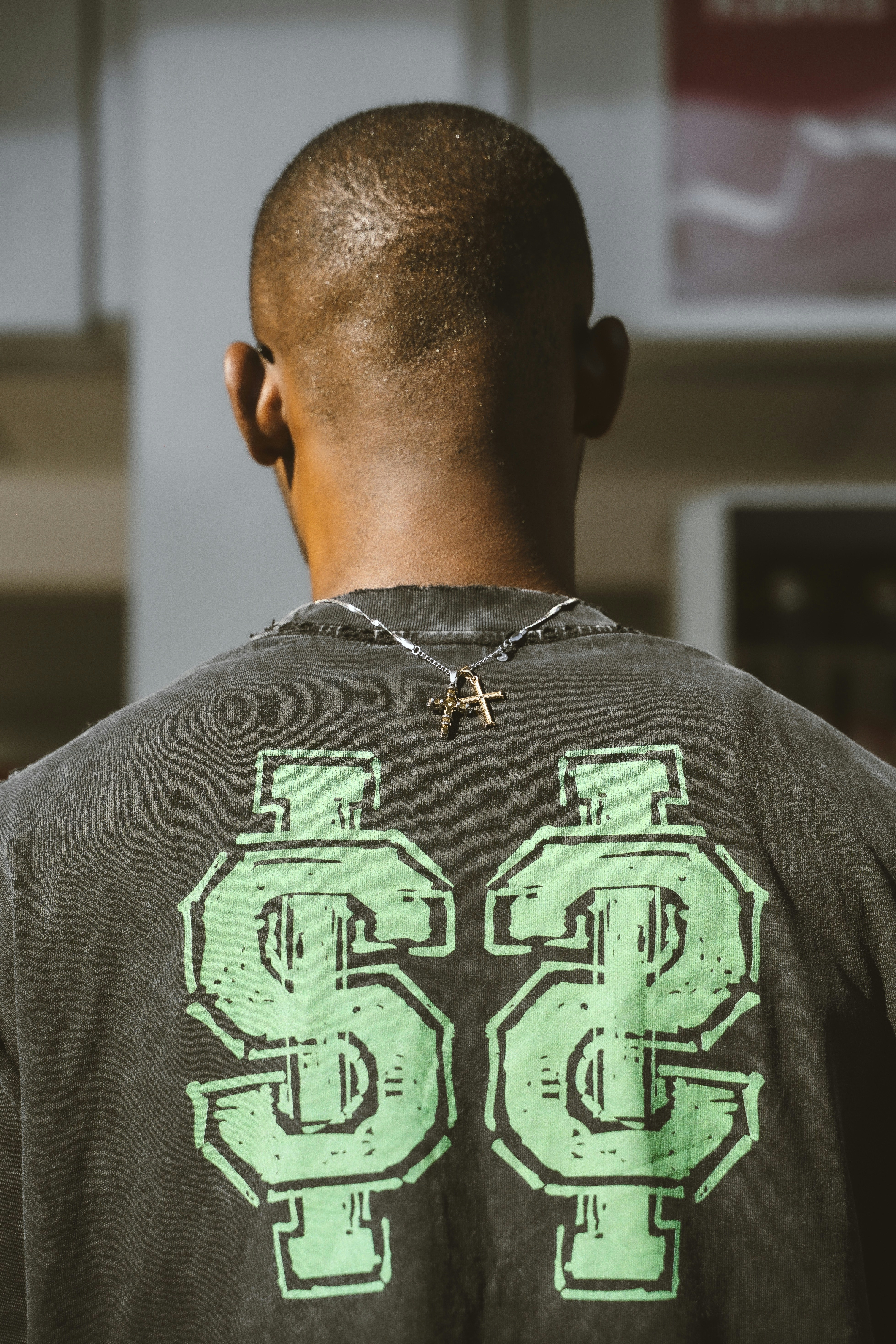 Man wearing a t-shirt with dollar signs.