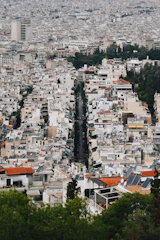 A dense cityscape with a long street running through it.