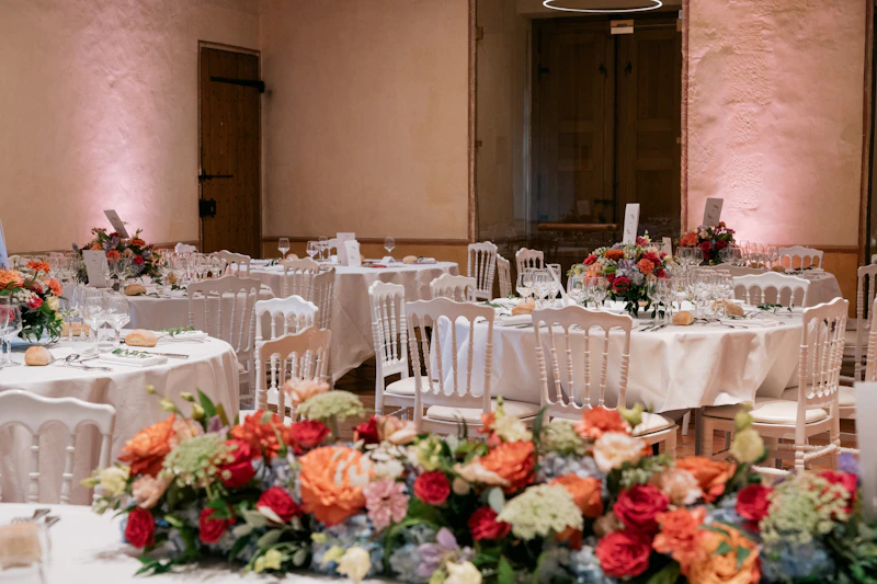 Reception tables set with lush floral centerpieces