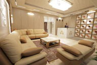 Modern hotel lobby with reception desk and seating area.