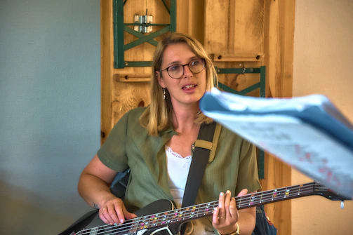 Woman playing bass guitar and singing