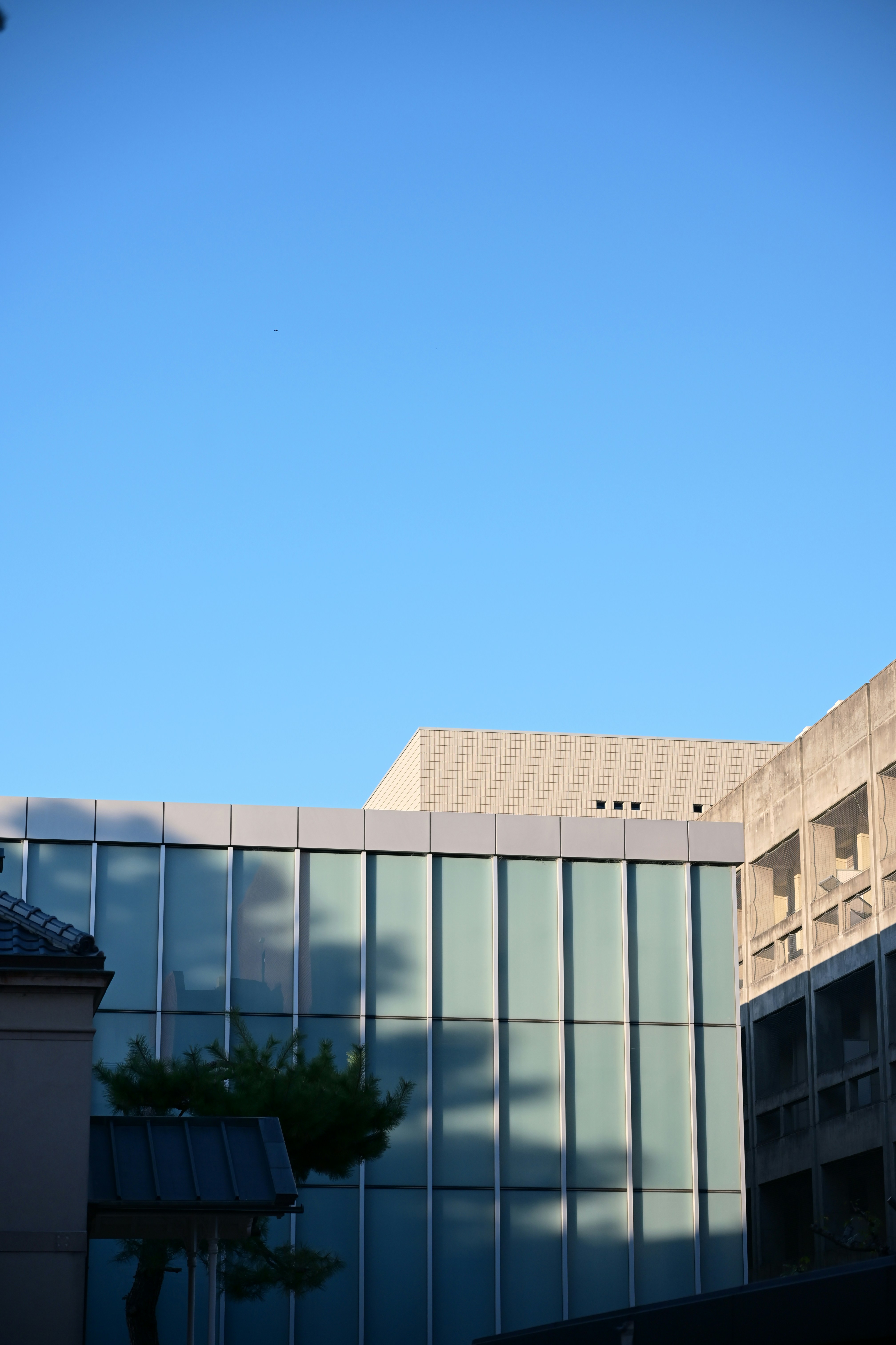 Modern buildings against a clear blue sky.