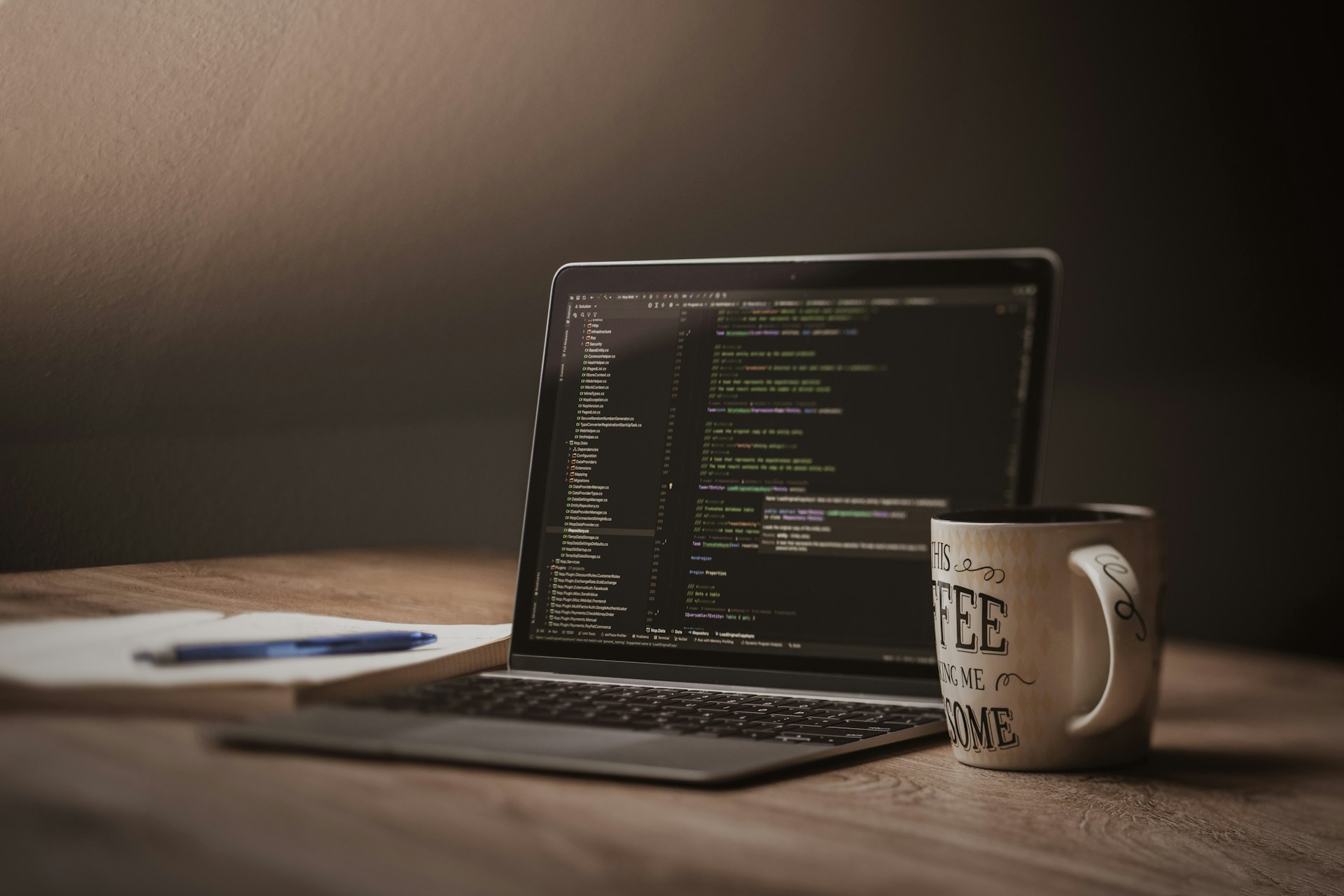Laptop screen displaying code with coffee mug.