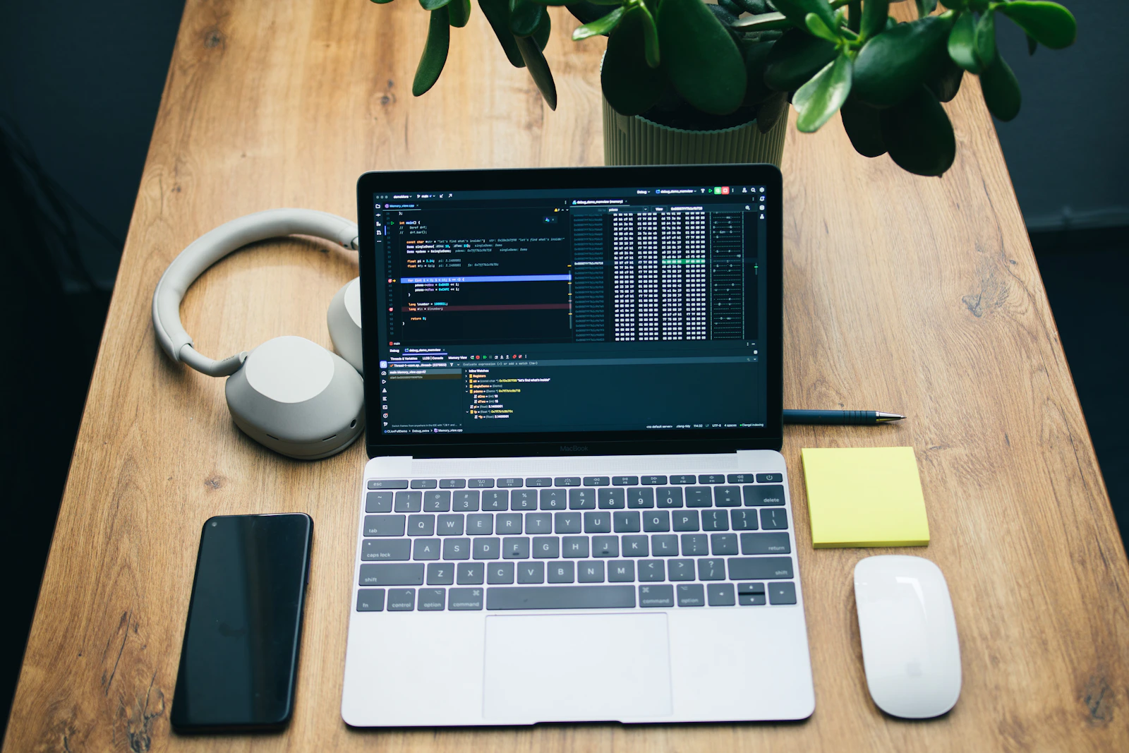 Laptop, headphones, smartphone and mouse arranged on a modern technology workspace