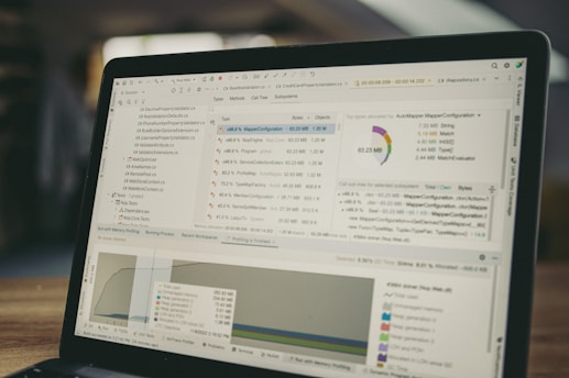 Laptop screen displaying code and data charts.