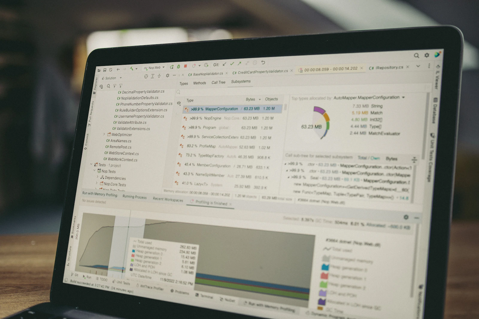 Laptop screen showing code, profiling data, and performance charts
