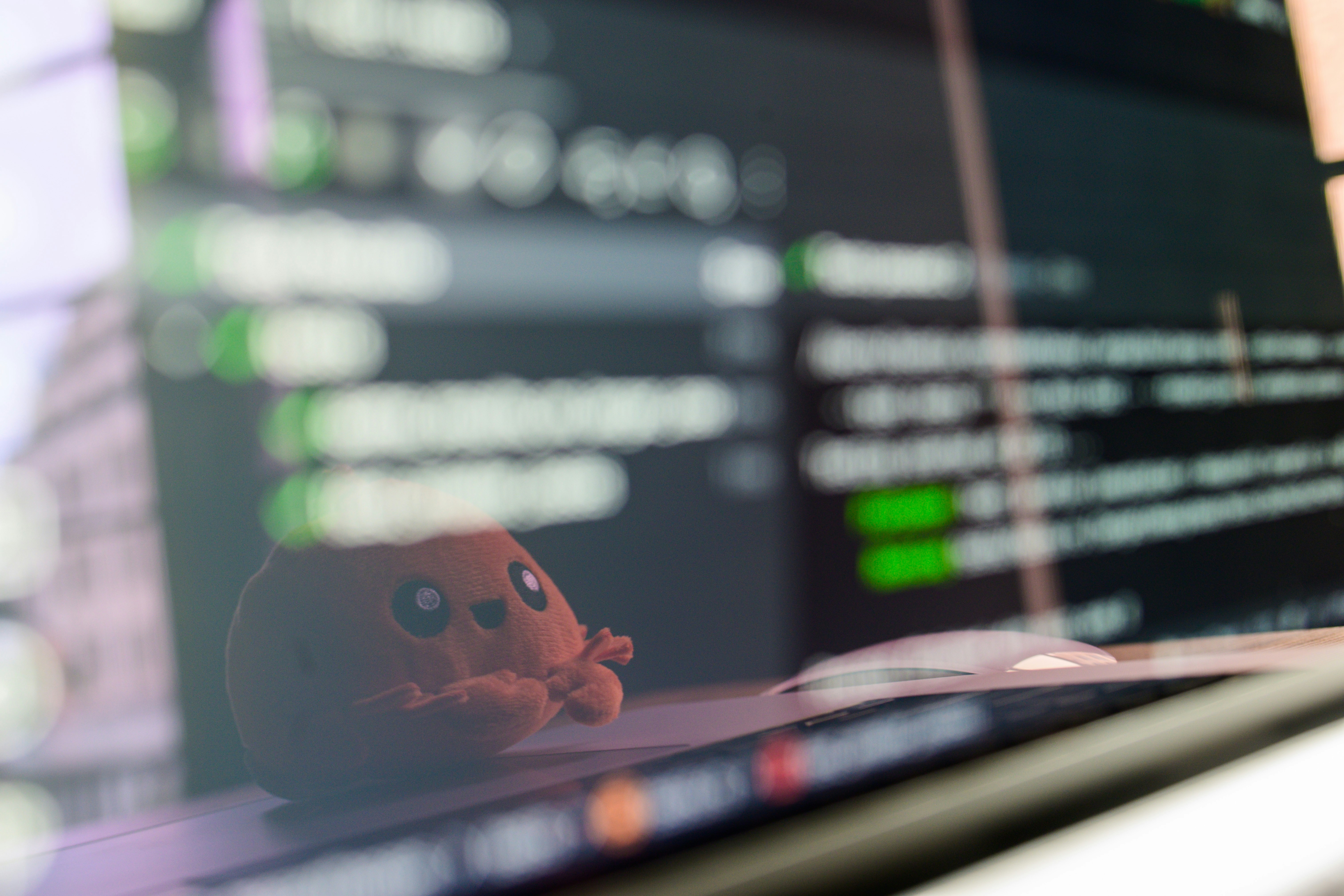 Small octopus toy rests on a laptop keyboard.