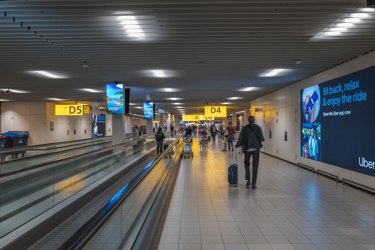 Travelers moving through an airport corridor