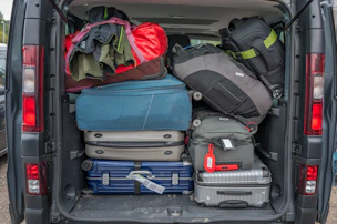 Van packed full with luggage for a trip.