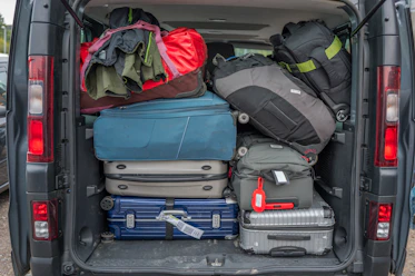 Van packed full with luggage for a trip.